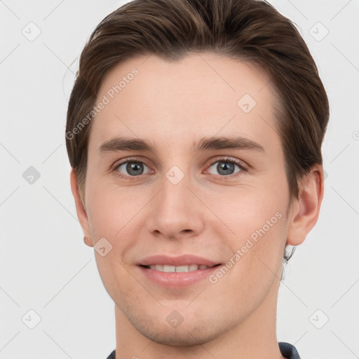 Joyful white young-adult male with short  brown hair and grey eyes