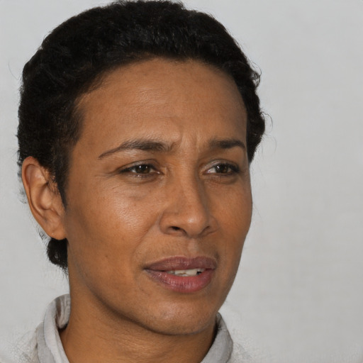 Joyful black adult female with short  brown hair and brown eyes
