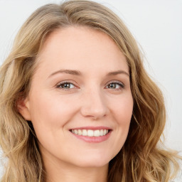 Joyful white young-adult female with long  brown hair and blue eyes