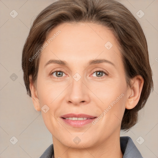 Joyful white adult female with medium  brown hair and grey eyes