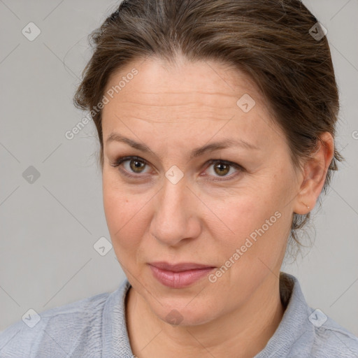 Joyful white adult female with medium  brown hair and grey eyes