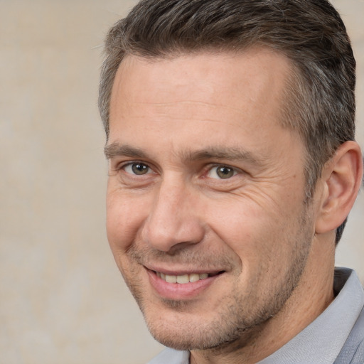 Joyful white adult male with short  brown hair and brown eyes