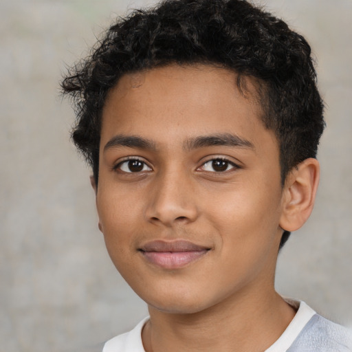 Joyful latino child male with short  brown hair and brown eyes