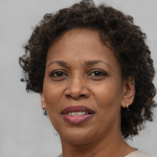 Joyful black adult female with short  brown hair and brown eyes