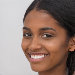 Joyful latino young-adult female with long  brown hair and brown eyes