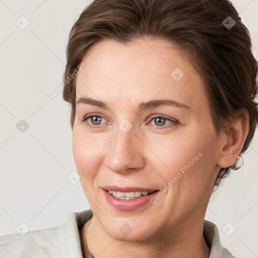 Joyful white adult female with short  brown hair and grey eyes