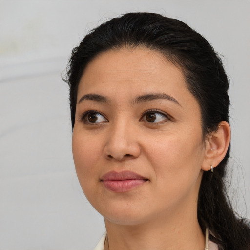 Joyful latino young-adult female with medium  brown hair and brown eyes