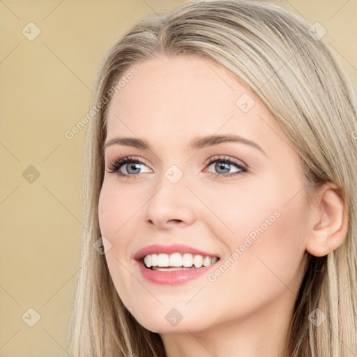 Joyful white young-adult female with long  brown hair and blue eyes