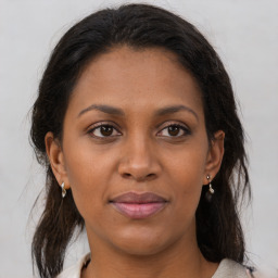 Joyful black adult female with medium  brown hair and brown eyes