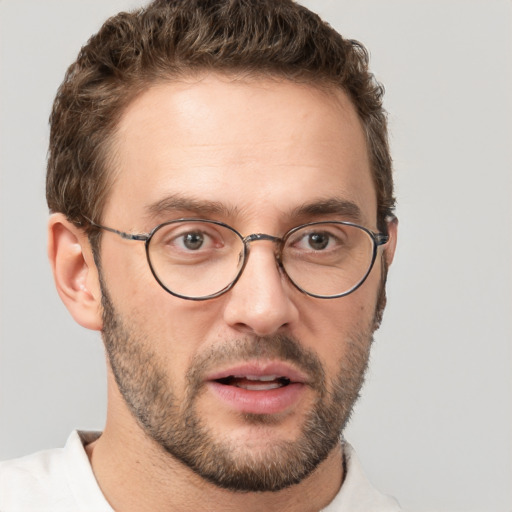 Joyful white adult male with short  brown hair and brown eyes