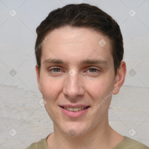 Joyful white young-adult male with short  brown hair and grey eyes