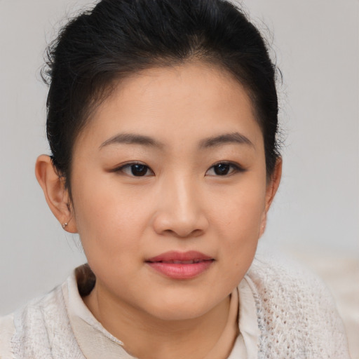 Joyful asian young-adult female with short  brown hair and brown eyes