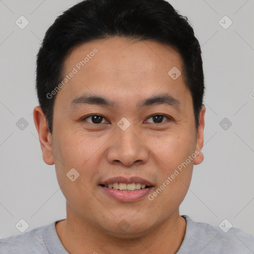 Joyful asian young-adult male with short  brown hair and brown eyes