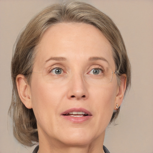 Joyful white adult female with medium  brown hair and grey eyes