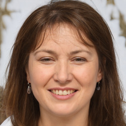 Joyful white adult female with long  brown hair and brown eyes