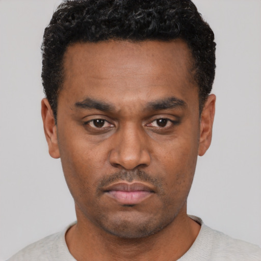 Neutral black young-adult male with short  black hair and brown eyes