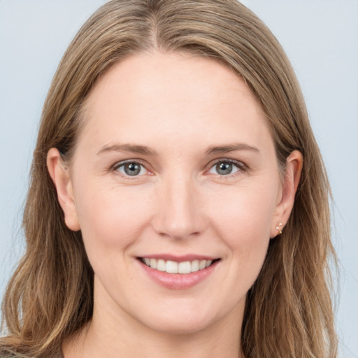 Joyful white young-adult female with long  brown hair and grey eyes