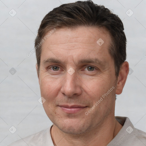 Joyful white adult male with short  brown hair and brown eyes