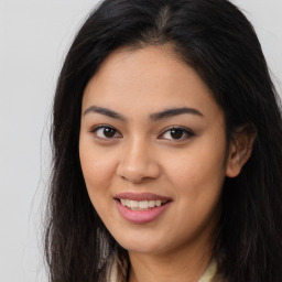 Joyful asian young-adult female with long  brown hair and brown eyes