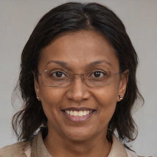 Joyful black adult female with medium  brown hair and brown eyes