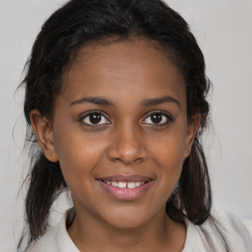 Joyful black young-adult female with medium  brown hair and brown eyes