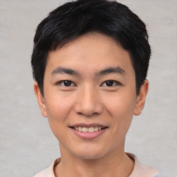 Joyful asian young-adult male with short  black hair and brown eyes