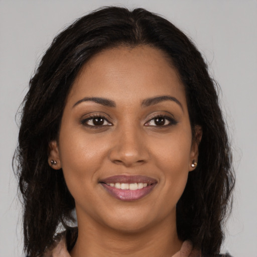 Joyful latino young-adult female with long  brown hair and brown eyes