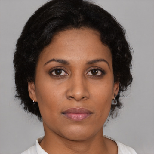 Joyful black young-adult female with medium  brown hair and brown eyes