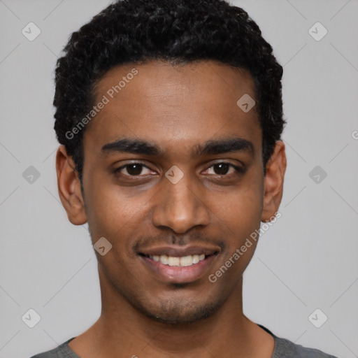 Joyful black young-adult male with short  black hair and brown eyes