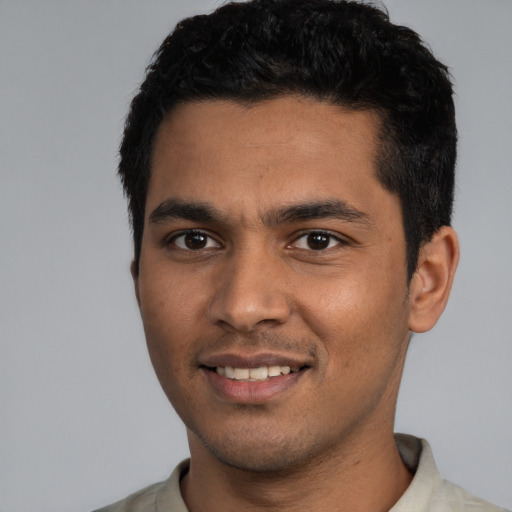Joyful white young-adult male with short  black hair and brown eyes