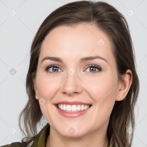 Joyful white young-adult female with medium  brown hair and grey eyes