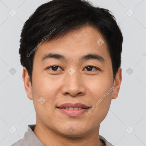 Joyful asian young-adult male with short  brown hair and brown eyes