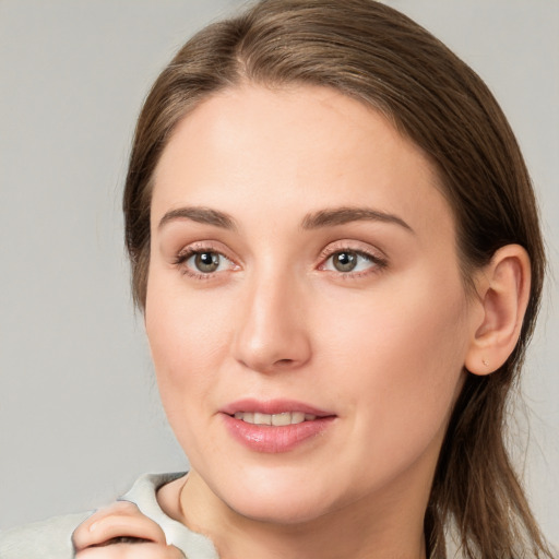 Joyful white young-adult female with long  brown hair and grey eyes