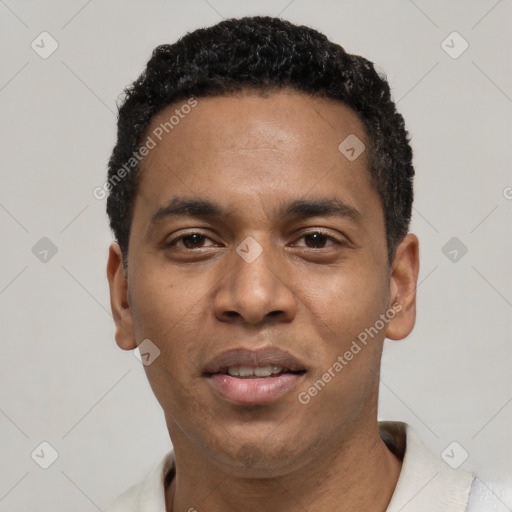 Joyful black young-adult male with short  black hair and brown eyes