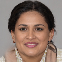 Joyful white adult female with medium  brown hair and brown eyes