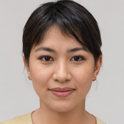 Joyful asian young-adult female with medium  brown hair and brown eyes