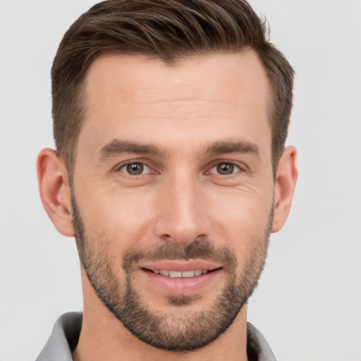 Joyful white young-adult male with short  brown hair and brown eyes