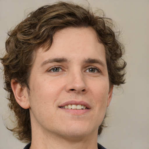 Joyful white young-adult male with medium  brown hair and brown eyes