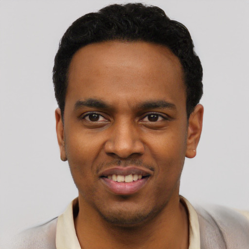 Joyful black young-adult male with short  black hair and brown eyes