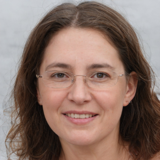 Joyful white adult female with long  brown hair and brown eyes