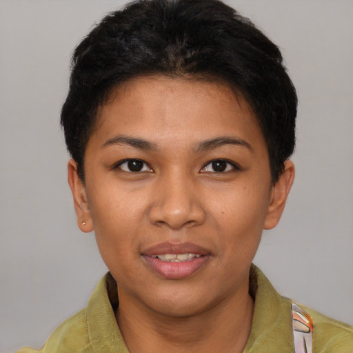 Joyful latino young-adult female with short  black hair and brown eyes