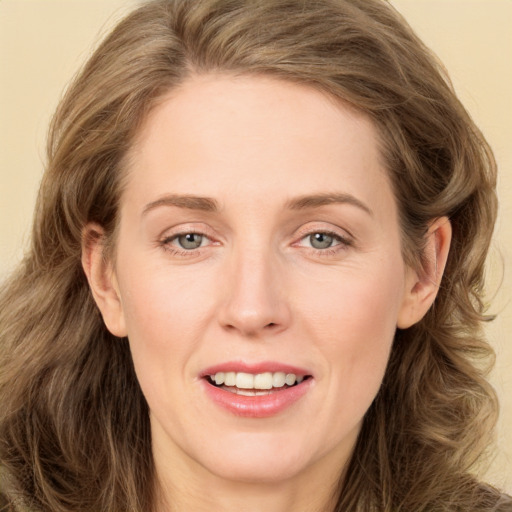 Joyful white young-adult female with long  brown hair and green eyes