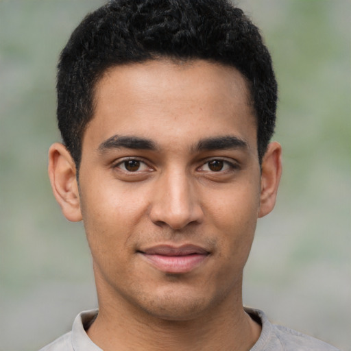 Joyful latino young-adult male with short  brown hair and brown eyes