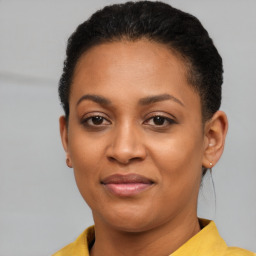 Joyful black young-adult female with short  brown hair and brown eyes