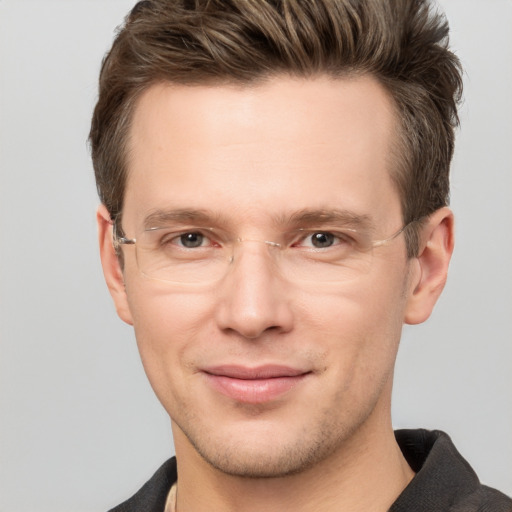 Joyful white young-adult male with short  brown hair and grey eyes