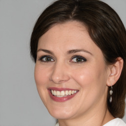 Joyful white adult female with medium  brown hair and brown eyes