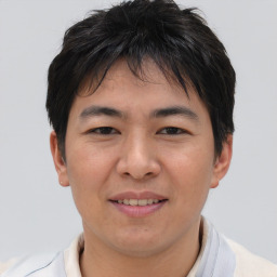 Joyful asian young-adult male with short  brown hair and brown eyes