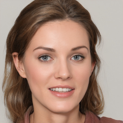 Joyful white young-adult female with medium  brown hair and grey eyes