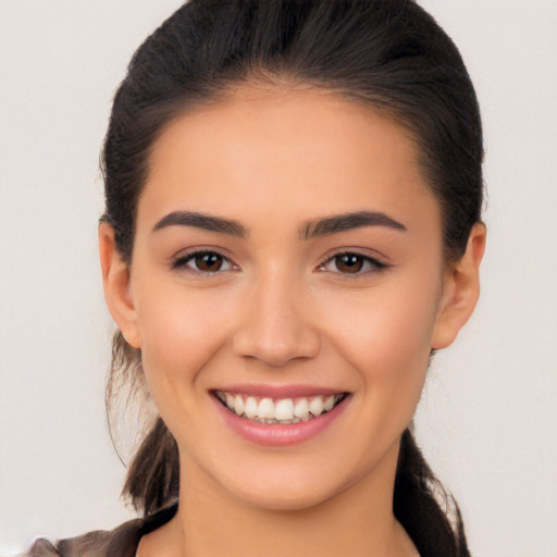 Joyful latino young-adult female with long  brown hair and brown eyes