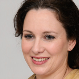 Joyful white adult female with medium  brown hair and brown eyes